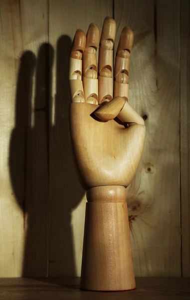 Mano di legno su sfondo di legno — Foto Stock