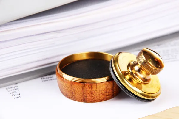 Wooden stamp and papers on table — Stock Photo, Image