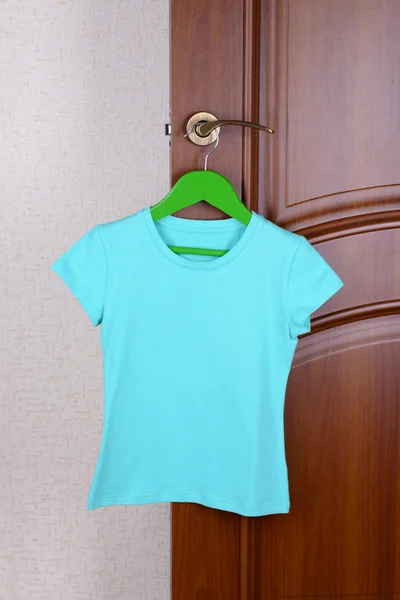 T-shirt hanging on door — Stock Photo, Image