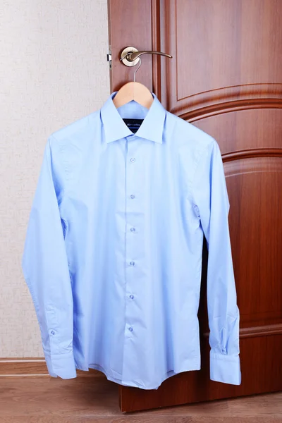 Shirt hanging on door — Stock Photo, Image