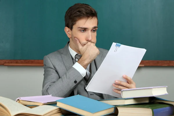 Joven profesor sentado en el aula de la escuela — Foto de Stock