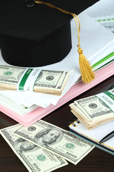 Гроші на випускні або навчання на дерев'яному столі крупним планом — стокове фото