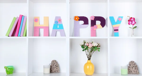 White shelves decorated with handmade knit word — Stock Photo, Image