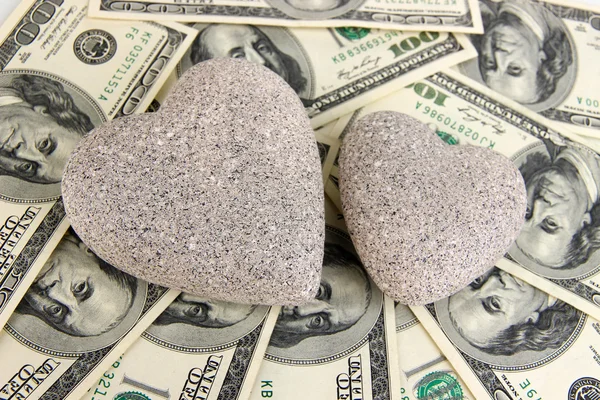 Love and money concept. Heart-shaped stone and American currency close up. — Stock Photo, Image