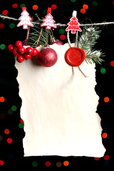 Blank sheet with Christmas decor on black background with lights — Stock Photo, Image