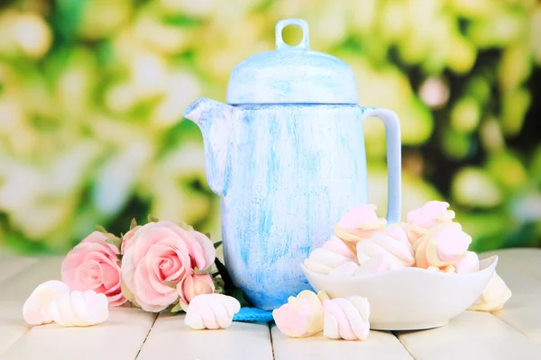 Antique white teapot on wooden table on natural background — Stock Photo, Image