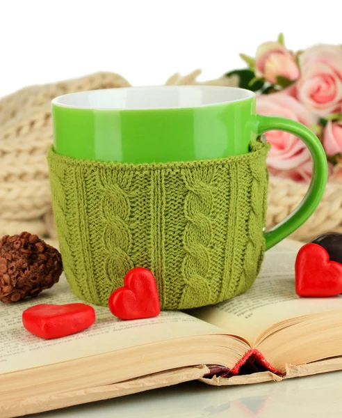 Cup with knitted thing on it and open book close up — Stock Photo, Image