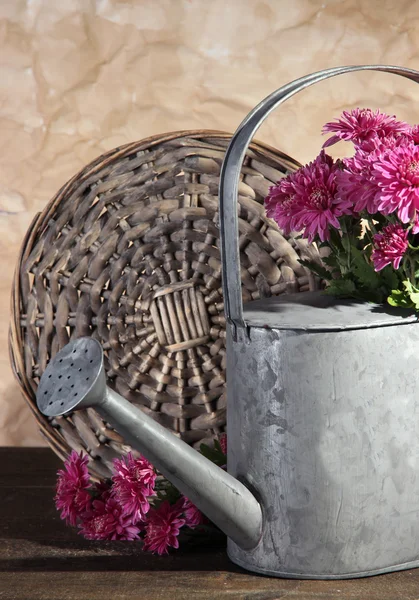 Boeket van roze chrysant in gieter op houten tafel — Stockfoto