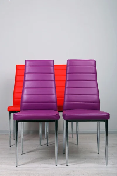 Modern color chairs on wall background — Stock Photo, Image