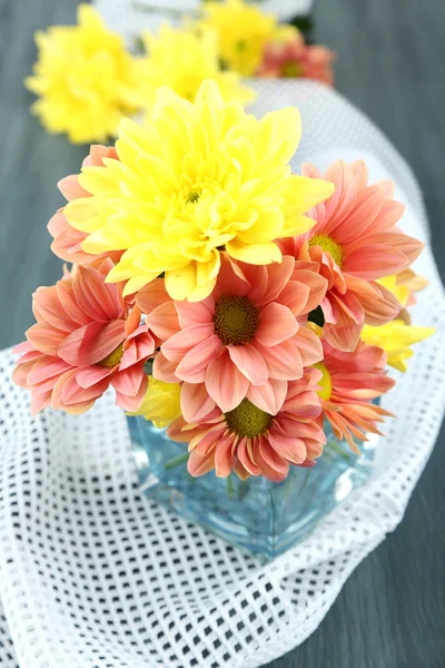Chrysanthemum flowers in vase on wooden table close-up — Stock Photo, Image