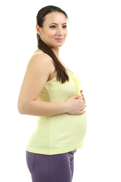 Красивая молодая беременная женщина прикасается к животу, изолированному на белом — стоковое фото