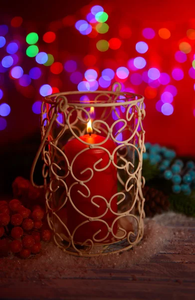 Candle and Christmas tree bud on wooden table on bright background background — Stock Photo, Image