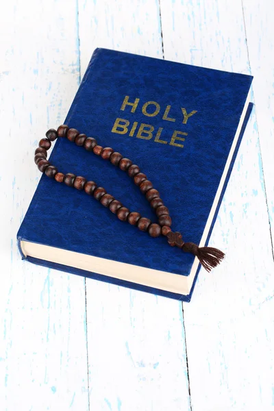 Библия с крестом на деревянном столе крупным планом — стоковое фото