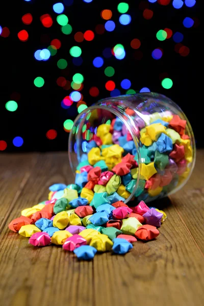 Paper stars with dreams on table on dark background — Stock Photo, Image