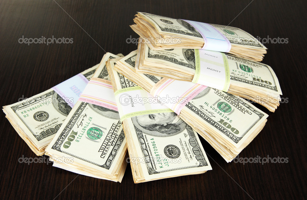 Stacks of money on wooden table