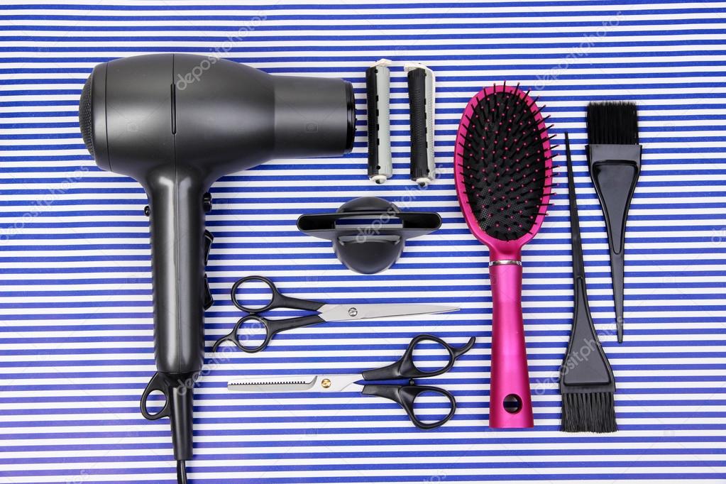 Hairdressing tools on striped blue background