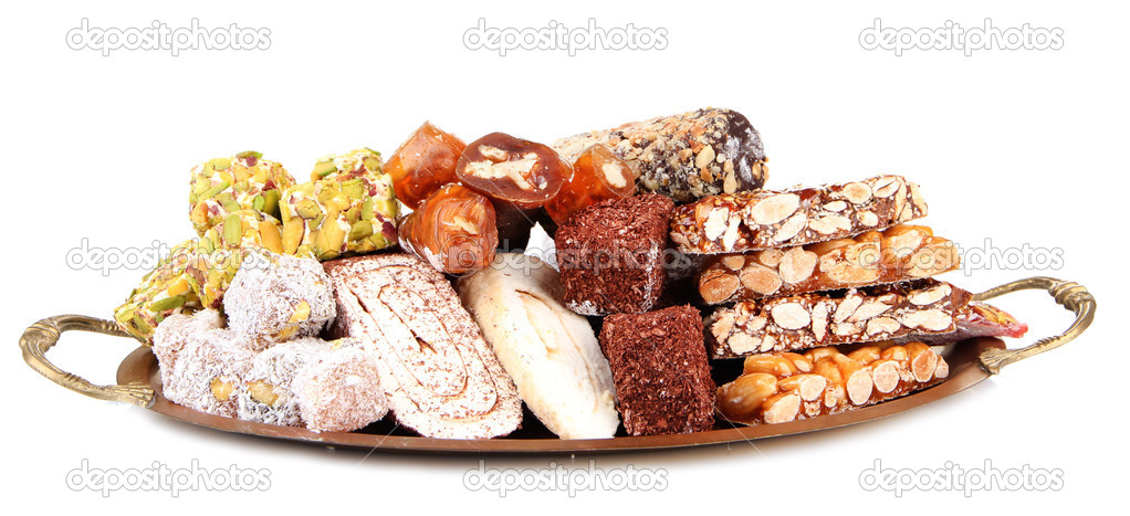 Tasty oriental sweets on metal tray, isolated on white