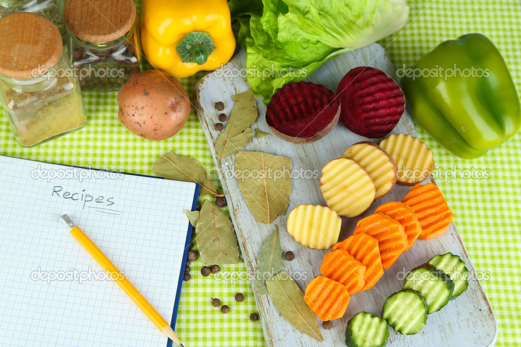 Beautiful sliced vegetables, on plate, on wooden background