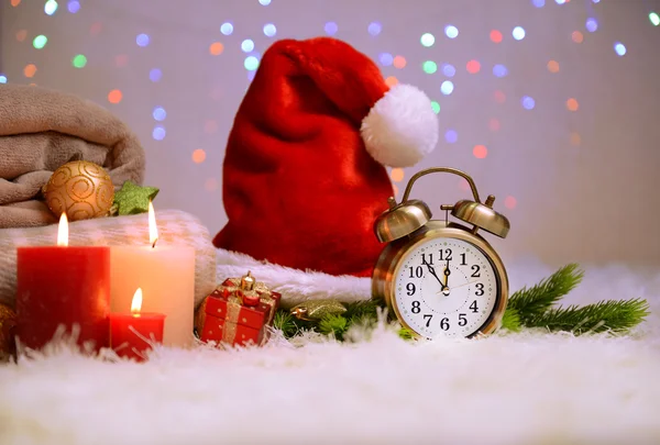 Composition avec plaids, bougies et décorations de Noël, sur tapis blanc sur fond lumineux — Photo