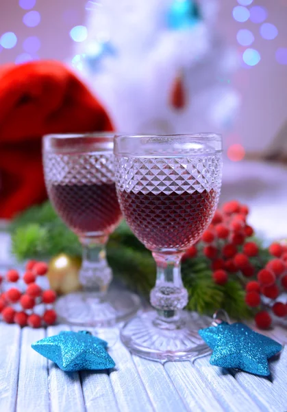 Wine glasses and Christmas decoration on bright background — Stock Photo, Image