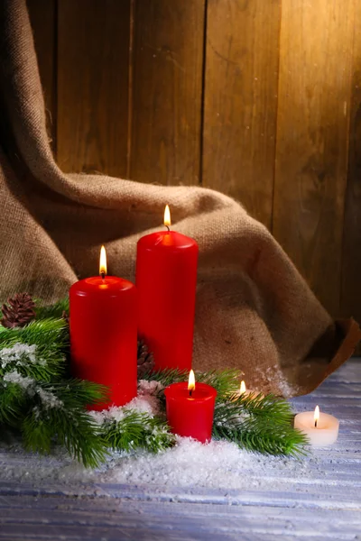 Velas y decoración navideña sobre fondo de madera — Foto de Stock