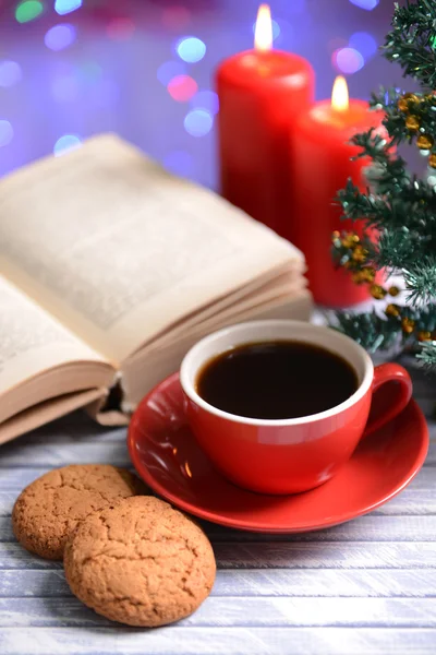 Composición del libro con taza de café y decoraciones navideñas en la mesa sobre fondo brillante —  Fotos de Stock