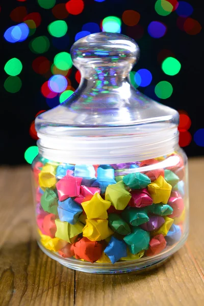 Paper stars with dreams on table on dark background — Stock Photo, Image