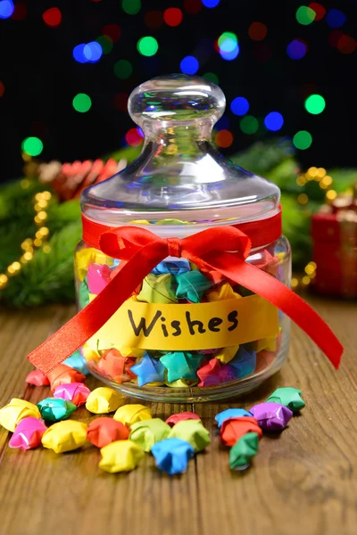 Paper stars with dreams on table on dark background — Stock Photo, Image