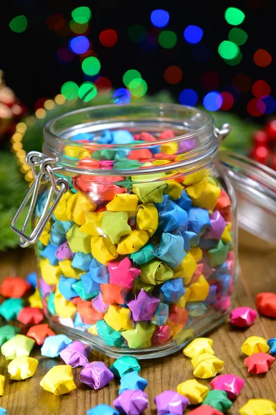 Paper stars with dreams on table on dark background — Stock Photo, Image