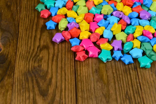 Paper stars with dreams on wooden background