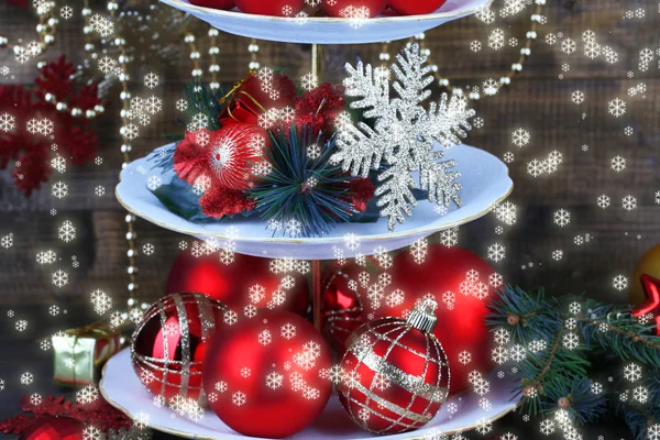 Christmas decorations on dessert stand, on wooden background — Stock Photo, Image