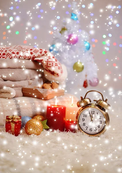 Composition with plaids, candles and Christmas decorations, on white carpet on bright background — Stock Photo, Image