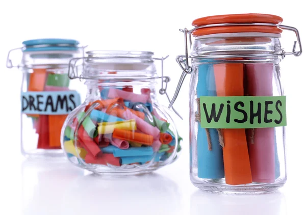 Dreams written on color rolled paper in glass jar, isolated on white — Stock Photo, Image