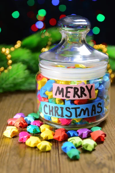 Paper stars with dreams on table on dark background — Stock Photo, Image