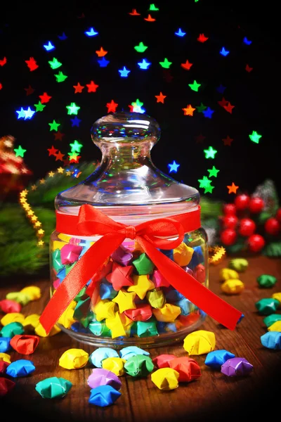 Paper stars with dreams on table on dark background — Stock Photo, Image