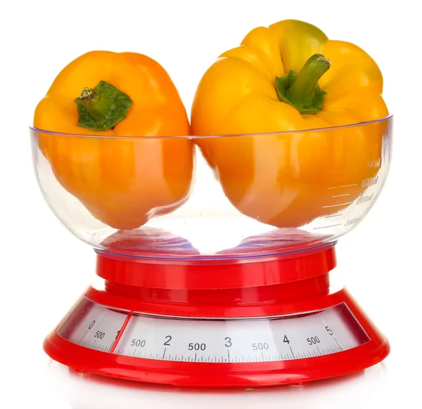 Fresh orange peppers in a kitchen scales isolated on white — Stock Photo, Image