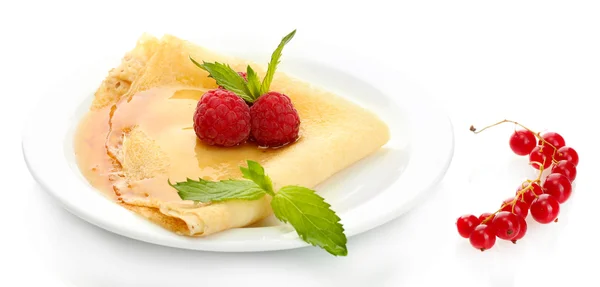 Delicious pancake with berries and honey on plate on wooden table — Stock Photo, Image