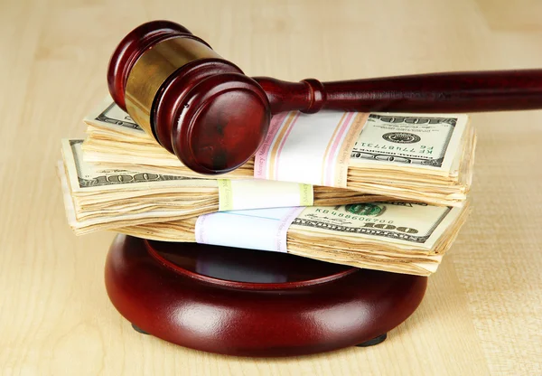 Stacks of money and judges gavel on wooden table — Stock Photo, Image