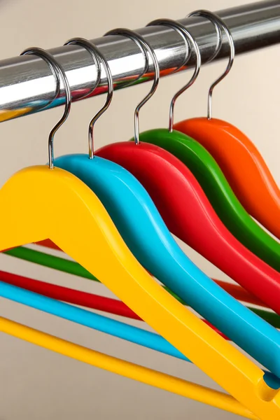 Kleurrijke kleerhangers op grijze achtergrond — Stockfoto