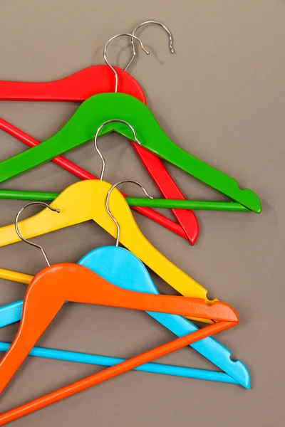 Colorful clothes hangers on gray background — Stock Photo, Image