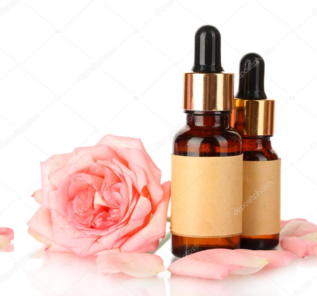 bottles of oil and rose isolated on white