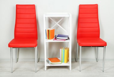 modern renkli sandalyeler, ahşap stand, duvar fon üzerine kitap ile güzel iç