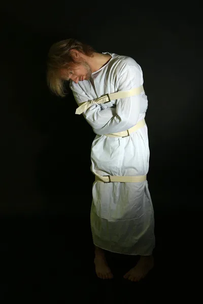 Mentally ill man in strait-jacket on black background — Stock Photo, Image