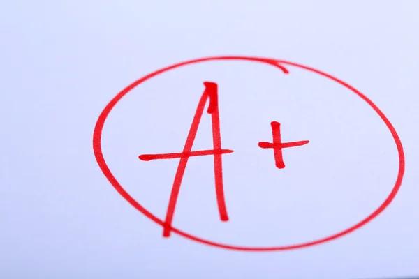 Grade A written on an exam paper — Stock Photo, Image