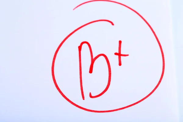 Grade B written on an exam paper — Stock Photo, Image