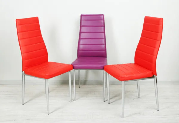 Modern color chairs on wall background — Stock Photo, Image