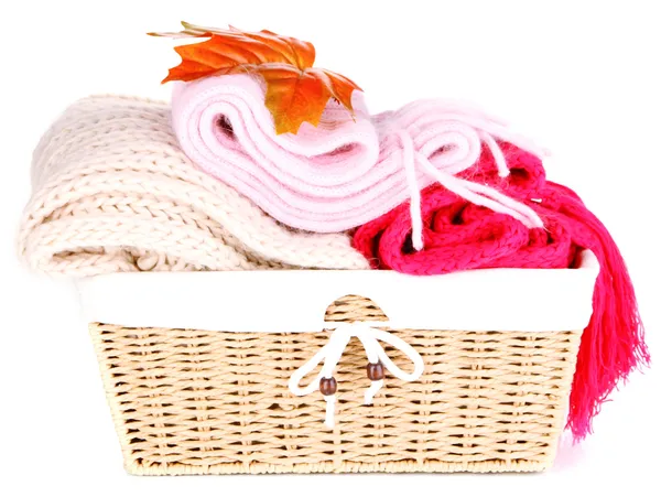 Warm knitted scarves in basket isolated on white — Stock Photo, Image