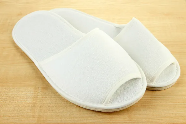 White slippers on wooden background — Stock Photo, Image