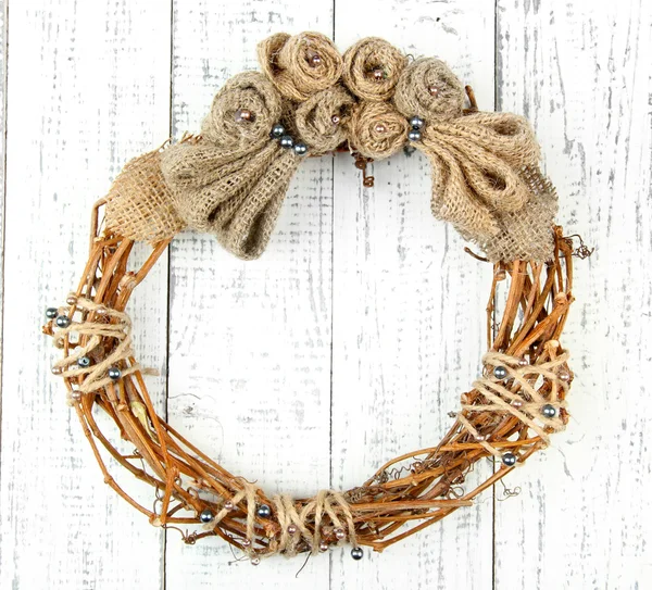 Beautiful rustic wreath, on wooden background — Stock Photo, Image