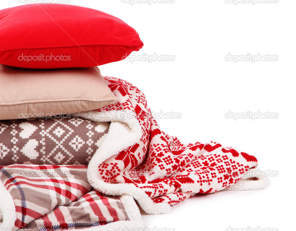 Warm plaids and pillows isolated on white
